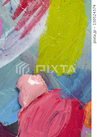 An artist's palette with multi-colored strokes of oil paint. 130524374