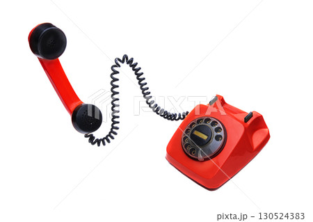 Red vintage telephone with a receiver on a white background. 130524383