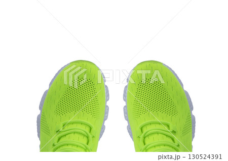 Green sneaker made of fabric on a white background 130524391
