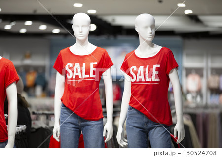 Mannequins in the store with the inscription SALE. 130524708