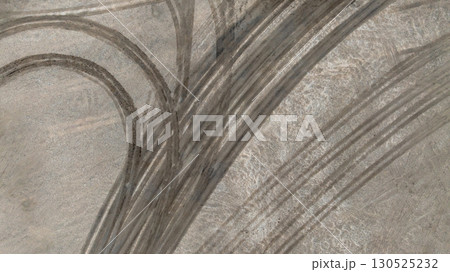 Aerial top view tire track on dirt sand mud, Texture of wet mud road with puddle and Tyre or tire track in countryside, Wheel tyre or tire track on mud, texture and background. 130525232