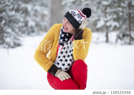 Happy middle-aged woman in the winter forest on a walk. Happy middle-aged woman in the winter forest on a walk. 130525438
