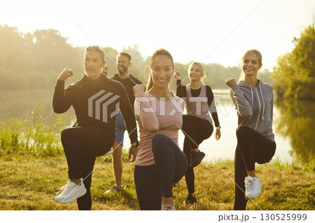 Group of fit and active people doing sport exercising in nature. Outdoors fitness concept. Group of fit and active people doing sport exercising in nature. Outdoors fitness concept. 130525999