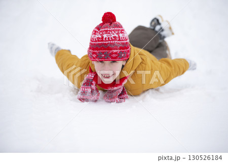 Happy little boy playing in the snow. Child in winter. 130526184