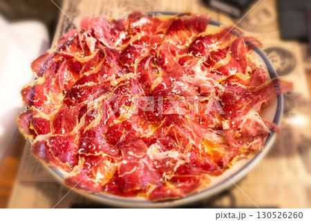 Plate of premium Spanish jamon served in a restaurant, thinly sliced 130526260