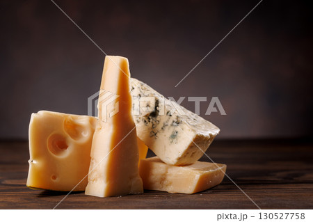Assorted cheeses in different shapes and textures displayed together 130527758