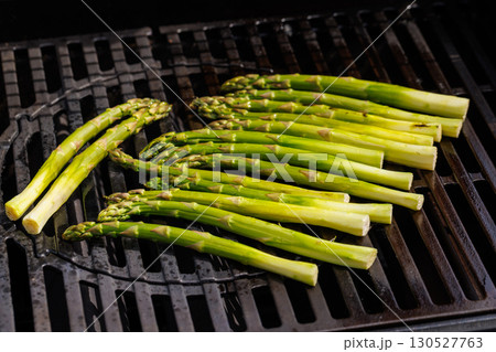 Fresh asparagus spears sizzling on a hot grill Fresh asparagus spears sizzling on a hot grill 130527763