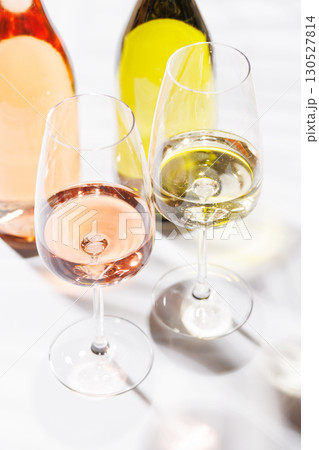 Wine glasses filled with white, and rose wine 130527814