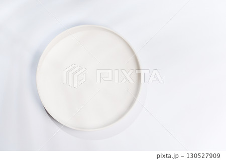 Empty plate on a white background with leaf shadows, perfect food mockup 130527909