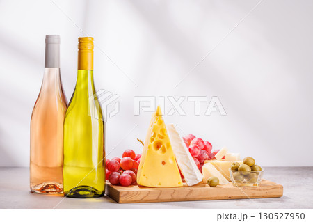 A delectable arrangement of various cheeses, fresh grapes, and wine A delectable arrangement of various cheeses, fresh grapes, and wine 130527950