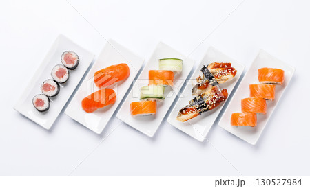 Assorted sushi and maki rolls beautifully arranged on plates 130527984