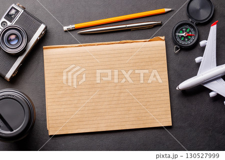 Creative flat lay of a travel-themed desk with notepad for plans Creative flat lay of a travel-themed desk with notepad for plans 130527999