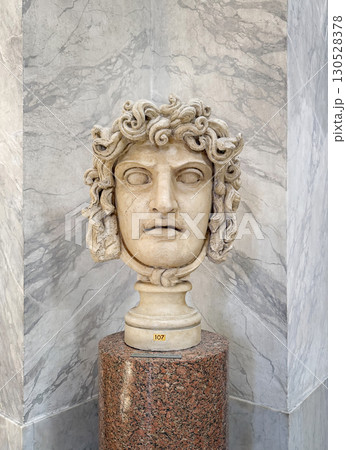 VATICAN CITY, ROME, ITALY - AUGUST 02, 2025 Classical marble head of Medusa, a fearsome Gorgon from Greek mythology with coiling snakes that form her hair, located in the Chiaramonti Museum 130528378