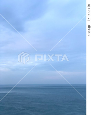 Calm seascape with soft blue sky and horizon. 130528416