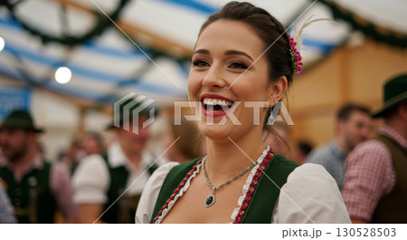 Cheerful woman in traditional dirndl dress celebrating Oktoberfest. Festive atmosphere, smiling and enjoying the event. Cheerful woman in traditional dirndl dress celebrating Oktoberfest. Festive atmosphere, smiling and enjoying the event. 130528503