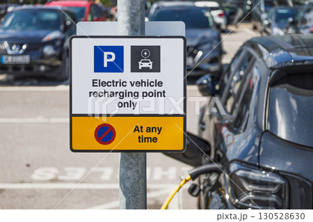 Electric vehicle recharging point only sign in car park. EV charging bay parking rules Electric vehicle recharging point only sign in car park. EV charging bay parking rules 130528630
