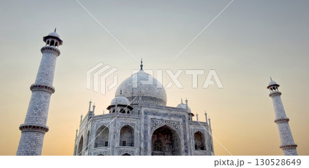 Taj Mahal in Agra, India. Marble mausoleum with intricate inlay, arches, minarets and symmetrical Taj Mahal in Agra, India. Marble mausoleum with intricate inlay, arches, minarets and symmetrical 130528649