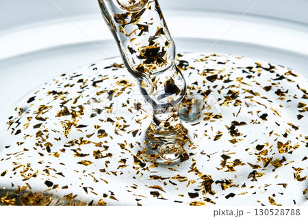 Mouth-watering thick texture of 24k gold serum. Mouth-watering thick texture of 24k gold serum. 130528788
