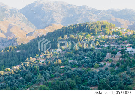 Mountain village Lakkoi in western Crete surrounded by pine forest on sunny day. 130528872