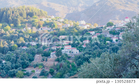Mountain village Lakkoi in western Crete surrounded by pine forest on sunny day. 130528873