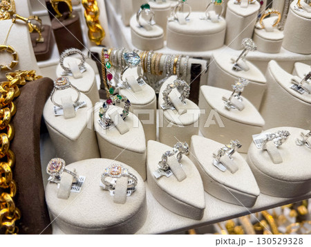 Silver rings and jewelry showcased in a store. Elegance, fashion, and retail through shiny accessories. 130529328