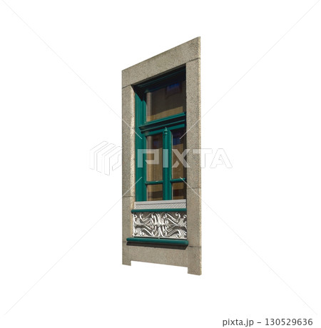Tall green framed window set in a stone wall with a decorative white ornamental panel beneath it. Tall green framed window set in a stone wall with a decorative white ornamental panel beneath it. 130529636