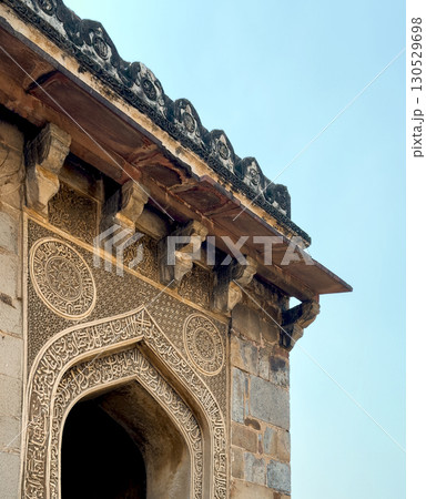 Delhi India October 15 2024 Close up of an intricately carved Islamic stone arch and overhanging Delhi India October 15 2024 Close up of an intricately carved Islamic stone arch and overhanging 130529698