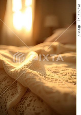 Comfortable textile bedding in softly lit bedroom. 130529758