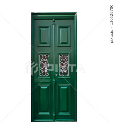 Elegant green wooden door with symmetrical paneling and two ornamental wrought iron grilles over Elegant green wooden door with symmetrical paneling and two ornamental wrought iron grilles over 130529780