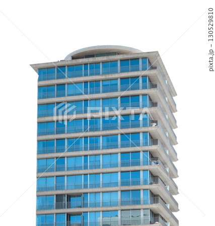 Modern high rise residential or office tower with stacked, offset floors and large blue tinted glass Modern high rise residential or office tower with stacked, offset floors and large blue tinted glass 130529810