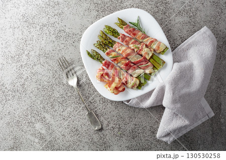 Grilled green asparagus wrapped in bacon. 130530258