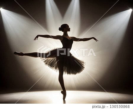 Silhouette of ballerina in graceful dance pose with glowing spotlight, cinematic elegant stage scene 130530868