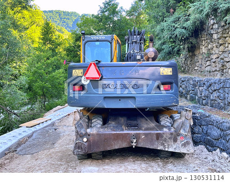 Bulldozer work near a waterfall in Jajce, Bosnia and Herzegovina Bulldozer work near a waterfall in Jajce, Bosnia and Herzegovina 130531114