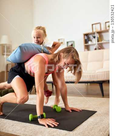 Mother Exercising at Home While Bonding with Her Daughter Mother Exercising at Home While Bonding with Her Daughter 130532421