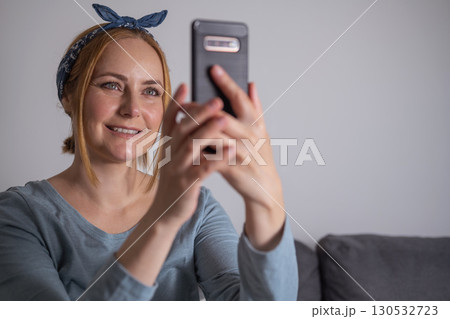 Middle aged millennial woman holding smartphone, social media, communication and modern technology Middle aged millennial woman holding smartphone, social media, communication and modern technology 130532723