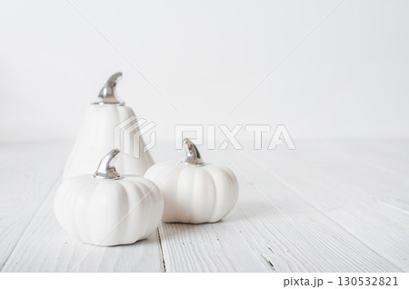 Minimalist White Pumpkins on White Wooden Background Minimalist White Pumpkins on White Wooden Background 130532821