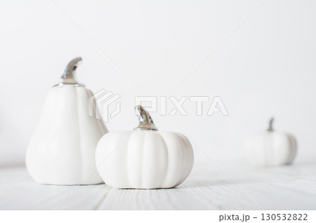 Minimalist White Pumpkins on White Wooden Background Minimalist White Pumpkins on White Wooden Background 130532822