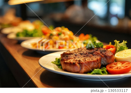 delicious grilled steak served with fresh salad and sides at a cozy restaurant 130533117