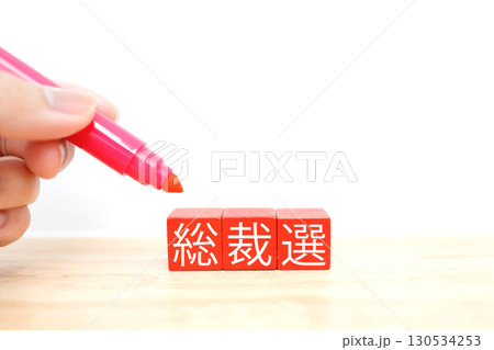 赤いブロックに書かれた総裁選の文字とコピースペース 130534253