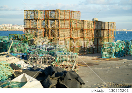 Crab Traps Stacked on the Dock Near the Waterfront 130535201