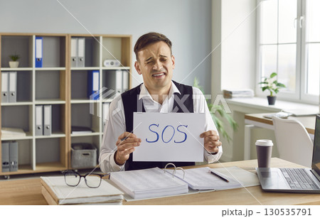 Portrait of a Troubled Businessman with Sos Sign 130535791