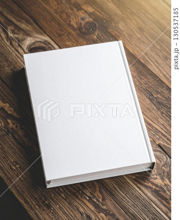 Blank White Book Cover on Rustic Brown Wooden Table with Soft Lighting and Open Grain 130537185