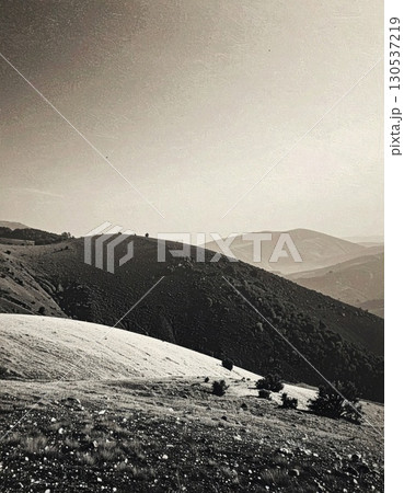 Sepia Tone Mountain Landscape With Rolling Hills Under a Partly Cloudy Sky in Countryside 130537219