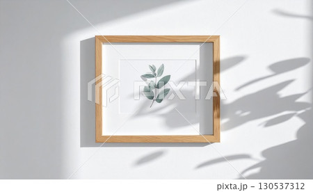 Botanical Artwork in Wood Frame with White Border on a White Wall with Natural Light and Shadows 130537312