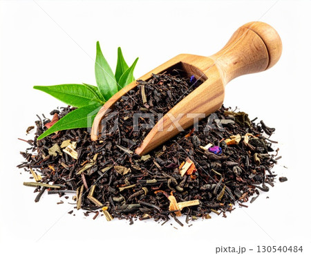Pile of Aromatic Black Tea Leaves with Wooden Spoon on White Background Studio Shot 130540484