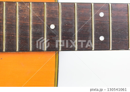 part of brown wood acoustic guitar isolated on white background 130541061