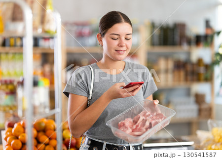 Young woman scanning qr code for lamb 130541587