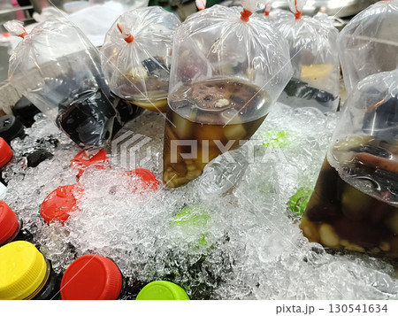 Bottled beverage with ice and fruit plastic bags colorful bottle caps cold drink refreshing drink chilled beverage fruit infusion beverage Bottled beverage with ice and fruit plastic bags colorful bottle caps cold drink refreshing drink chilled beverage fruit infusion beverage 130541634
