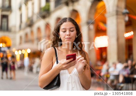 Young woman with phone walking around Barcelona Young woman with phone walking around Barcelona 130541808