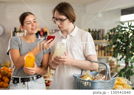 Couple man and woman scanning qr code for soda Couple man and woman scanning qr code for soda 130541840